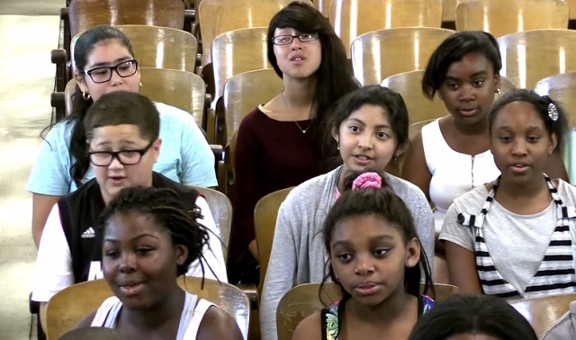 The teacher suffering from cancer starts crying when the school choir sings a song to her