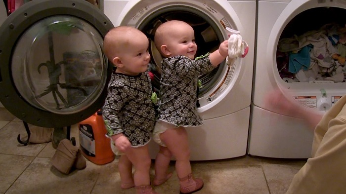 The mother tells the twins that it's time to do the laundry. Enjoy the girls' reaction