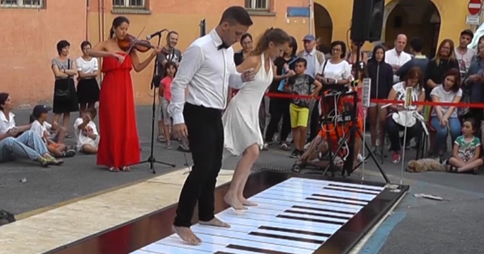 Two dancers step on a huge piano, and leave the audience speechless when they start to move